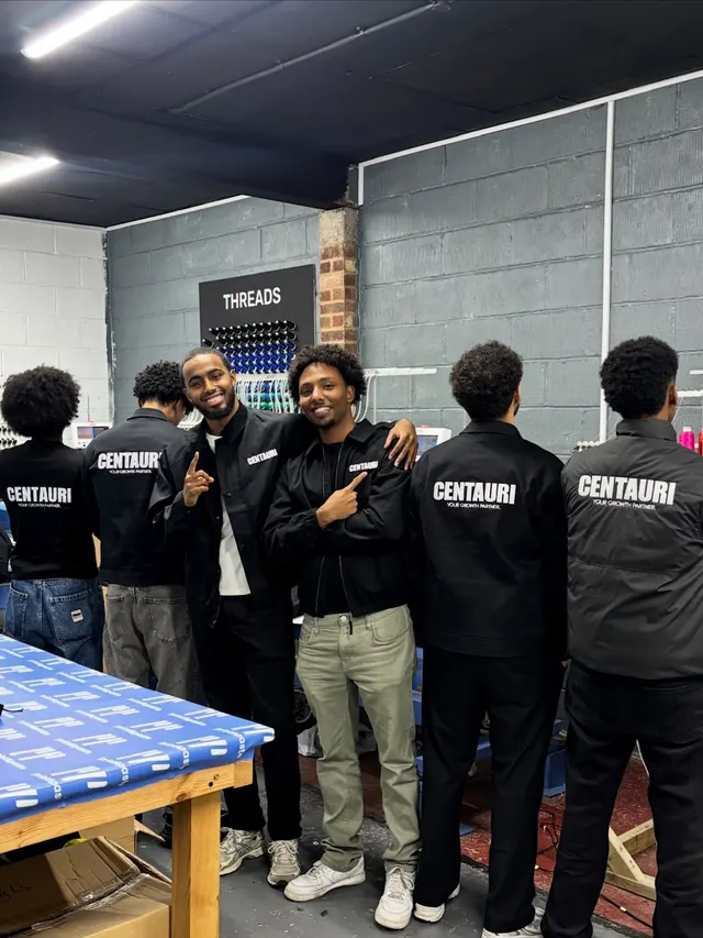 The Centauri crew in branded jackets at the print shop that made them.